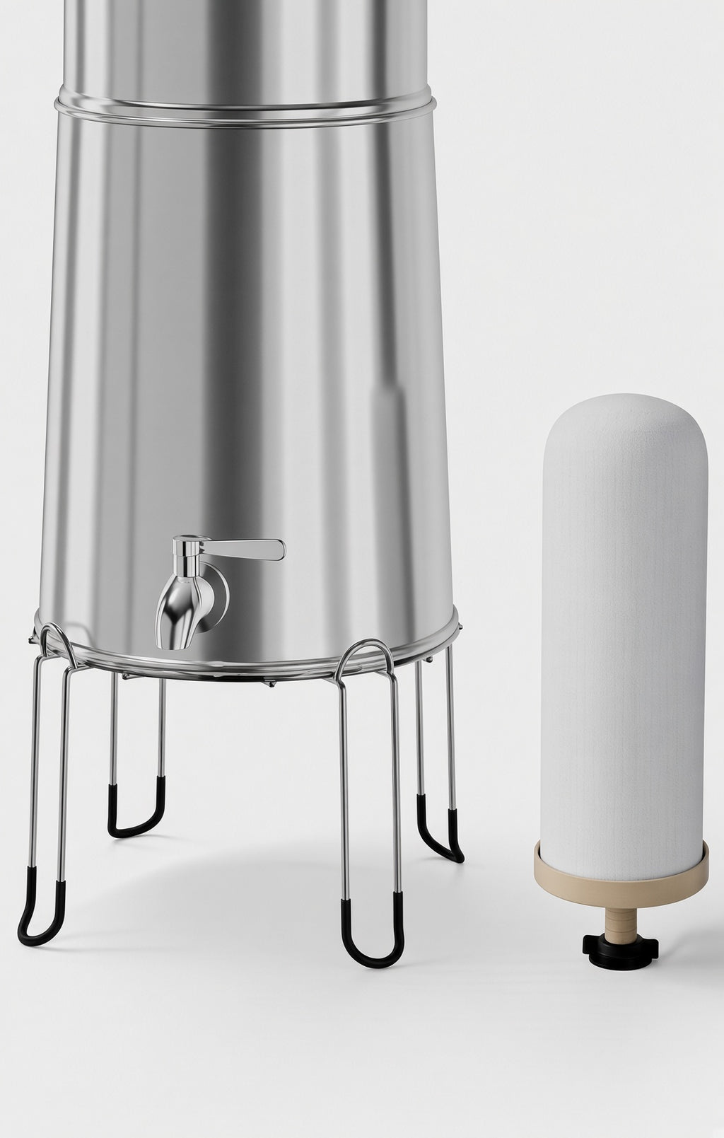 Close-up of gravity water filter spigot and stand beside a ceramic-style filter element for emergency water