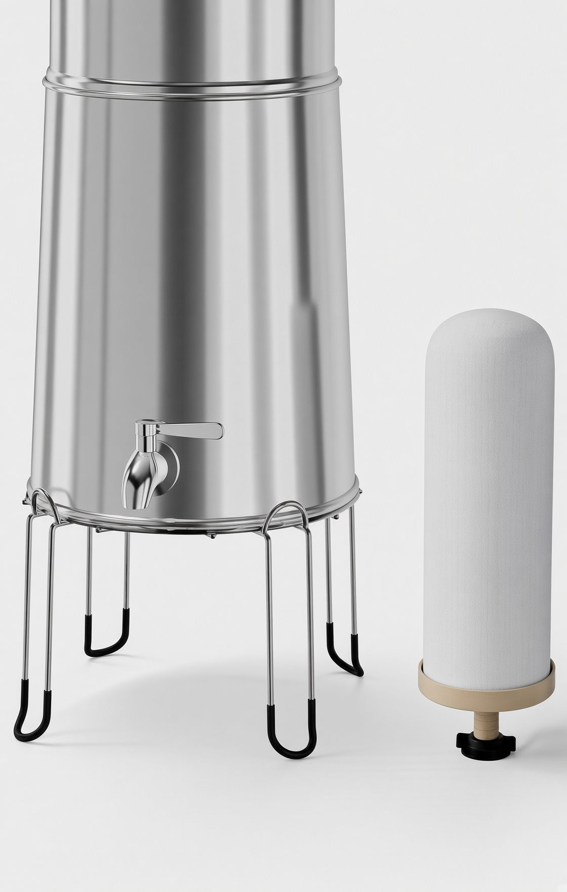 Close-up of gravity water filter spigot and stand beside a ceramic-style filter element for emergency water