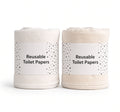 Two rolls of reusable cotton cloth, one white and one natural, with paper bands for off-grid hygiene